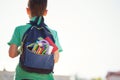 Boy with full school backpack. Little pupil going back to school. Back view