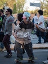 Boy with Funny Hat and Rasta Hair and with Joint Playing with his Skateboard during a Street Rave Party