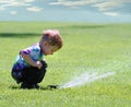 Boy and garden sprinkler Royalty Free Stock Photo