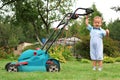 Boy Gardener mowing the lawn Royalty Free Stock Photo
