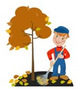 Boy gardener raking leaves in the garden Royalty Free Stock Photo