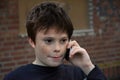 Teenage boy using cellphone, he gets bad news