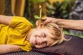 The boy gets a procedure with an ear candle, children`s ears health, good hearing, earwax