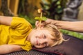 The boy gets a procedure with an ear candle, children`s ears health, good hearing, earwax