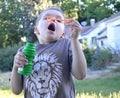 Boy getting ready to blow a big bubble!