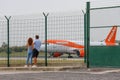 Boy and girl by the airport watching the easyjet airline plane Royalty Free Stock Photo