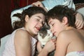 Boy and girl in bed with cat close up portrait Royalty Free Stock Photo