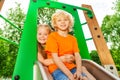 Boy and girl behind hug on chute with smile Royalty Free Stock Photo