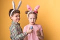 A boy with a girl with bunny ears hold Easter eggs in his hands Royalty Free Stock Photo