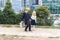 A boy and a girl in business clothes are walking along the road to hold hands in the business quarter Royalty Free Stock Photo