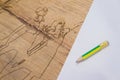 Boy and girl carving on the wood with pencil and paper