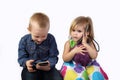 Boy and girl with cell phones on gray Royalty Free Stock Photo