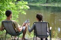 Boy and girl cheers with Budweiser Lager Alcohol Beer can during fishing. Budweiser is Brand from Anheuser-Busch Inbev most Royalty Free Stock Photo