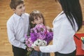 Boy and girl children give flowers as a school teacher Royalty Free Stock Photo