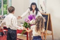 Boy and girl children give flowers as a school teacher in teache Royalty Free Stock Photo