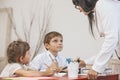 Boy and girl children with the teacher in the school Royalty Free Stock Photo