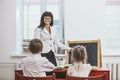 Boy and girl children with the teacher in the school Royalty Free Stock Photo