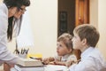 Boy and girl children with the teacher in the school Royalty Free Stock Photo