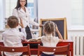 Boy and girl children with the teacher in the school has a happy Royalty Free Stock Photo