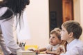 Boy and girl children with the teacher in the school has a happy Royalty Free Stock Photo