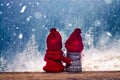 boy and girl christmas dolls in winter wonderland watching snowy