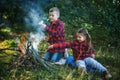 Boy and girl on a country picnic with a fire