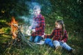 Boy and girl on a country picnic with a fire