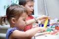 Boy and girl cutting paper for craft, brother and sister playing Royalty Free Stock Photo