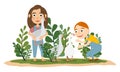 A boy and a girl in denim overalls are playing with gray and white geese. Royalty Free Stock Photo