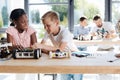 Boy and girl discussing the construction of a robotic car