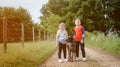 Boy and girl with the dog outdoors. Children walking together in park. Kids with pet animal. Royalty Free Stock Photo