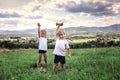 Boy and girl doing the morning exercises with dumbbell on the top of the mountains in summer Royalty Free Stock Photo