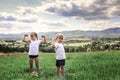 Boy and girl doing the morning exercises with dumbbell on the top of the mountains in summer Royalty Free Stock Photo