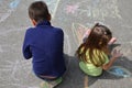 Boy and girl drawing with chalk home orphan child dream. children paint on the pavement. happy childhood on the street Royalty Free Stock Photo