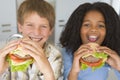 Boy and girl eating healthy burgers Royalty Free Stock Photo