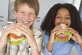 Boy and girl eating healthy burgers Royalty Free Stock Photo