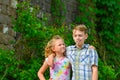A boy and a girl are embraced in a park on the street and my sister is looking at her brother from below Royalty Free Stock Photo
