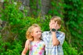 A boy and a girl are embraced in a park on the street and my sister is looking at her brother from below Royalty Free Stock Photo