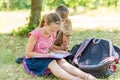 A boy and a girl are engaged in education and doing lessons in nature, preparing for entrance and final exams Royalty Free Stock Photo