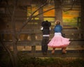 Boy and girl on fence