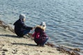 Boy and girl `fishing` on the lake with sticks Royalty Free Stock Photo