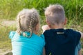 Boy and girl friends brother sister sitting on the ground Royalty Free Stock Photo