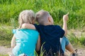 Boy and girl friends brother sister sitting on the ground Royalty Free Stock Photo
