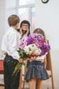 Boy and girl give flowers as a school teacher in teacher`s day Royalty Free Stock Photo