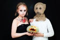 Boy and Girl with Halloween Makeup holding Pumpkin