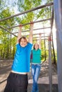 Boy and girl hanging on the brachiating bar Royalty Free Stock Photo