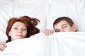 Boy and girl are hiding under the blanket Royalty Free Stock Photo