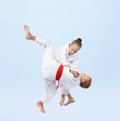 Boy and girl in judogi are training throws Royalty Free Stock Photo