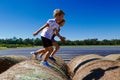 Boy and girl jumping and running on haystacks