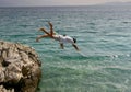 Boy and girl jumping into the sea Royalty Free Stock Photo